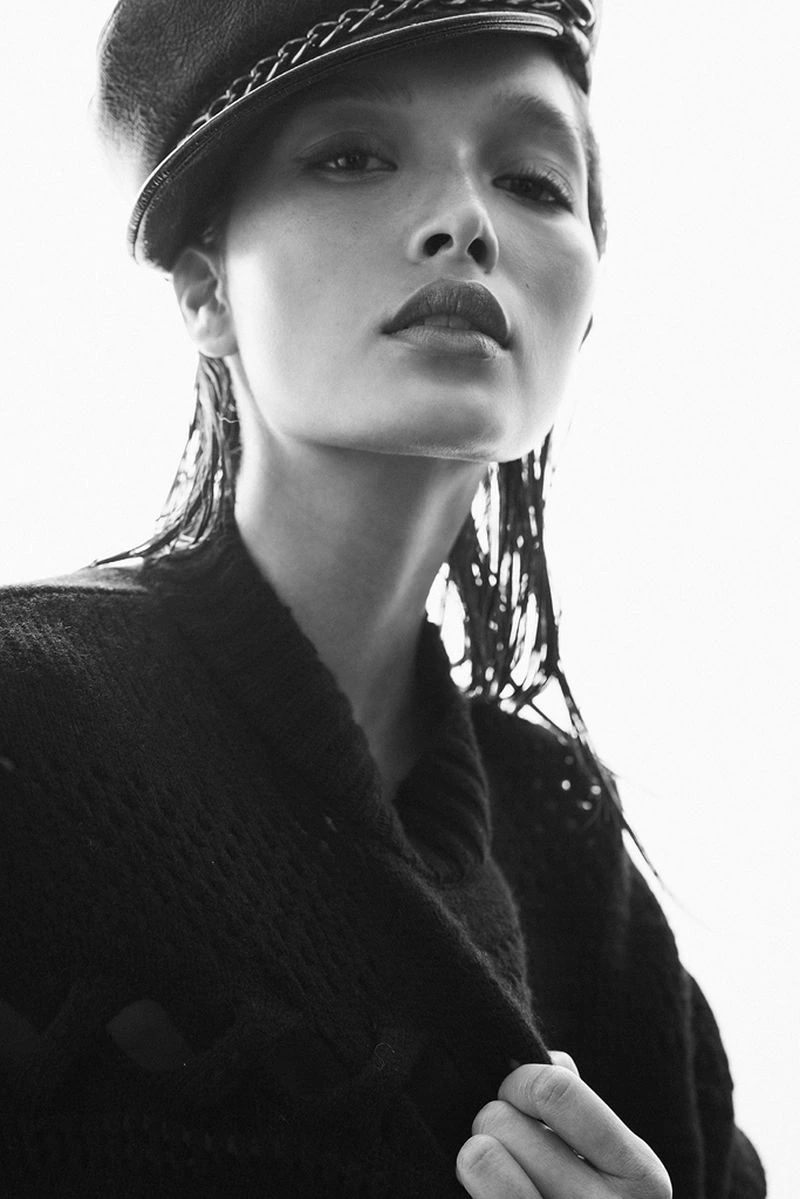Black-and-white editorial portrait of Yada Villaret wearing a cap and coat